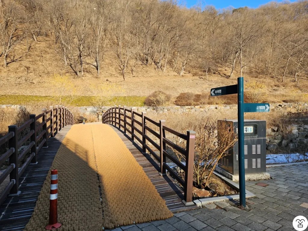 After entering, find the bridge on the left and cross it.